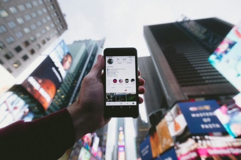 Person using a smartphone to browse social media content and ads