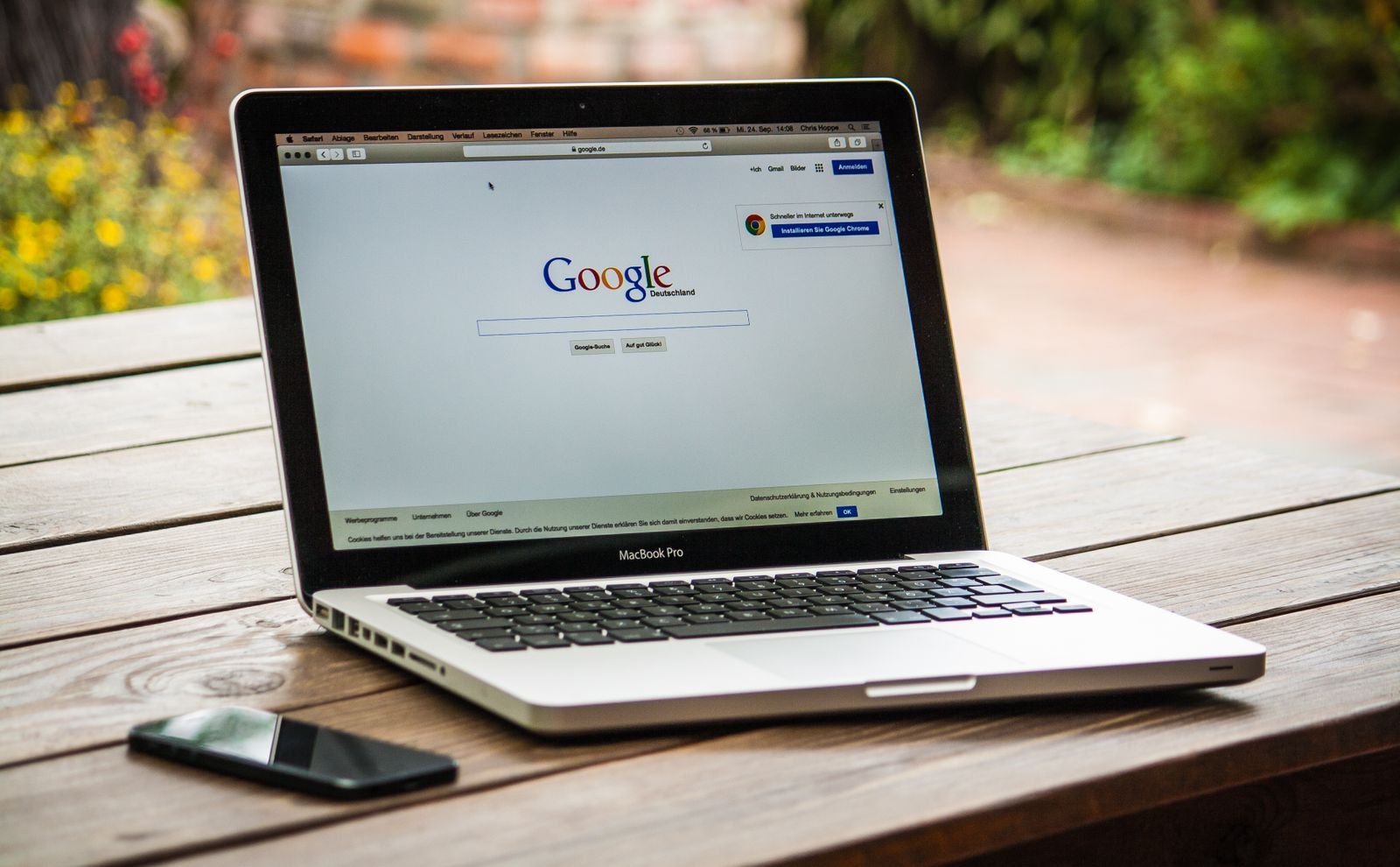 Laptop displaying Google Search results on a wooden desk