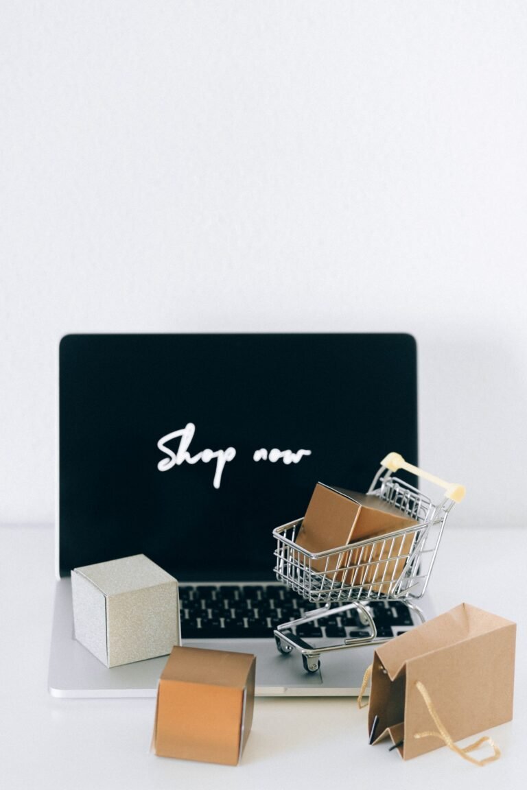 Minimal laptop, cart and packages on a light background