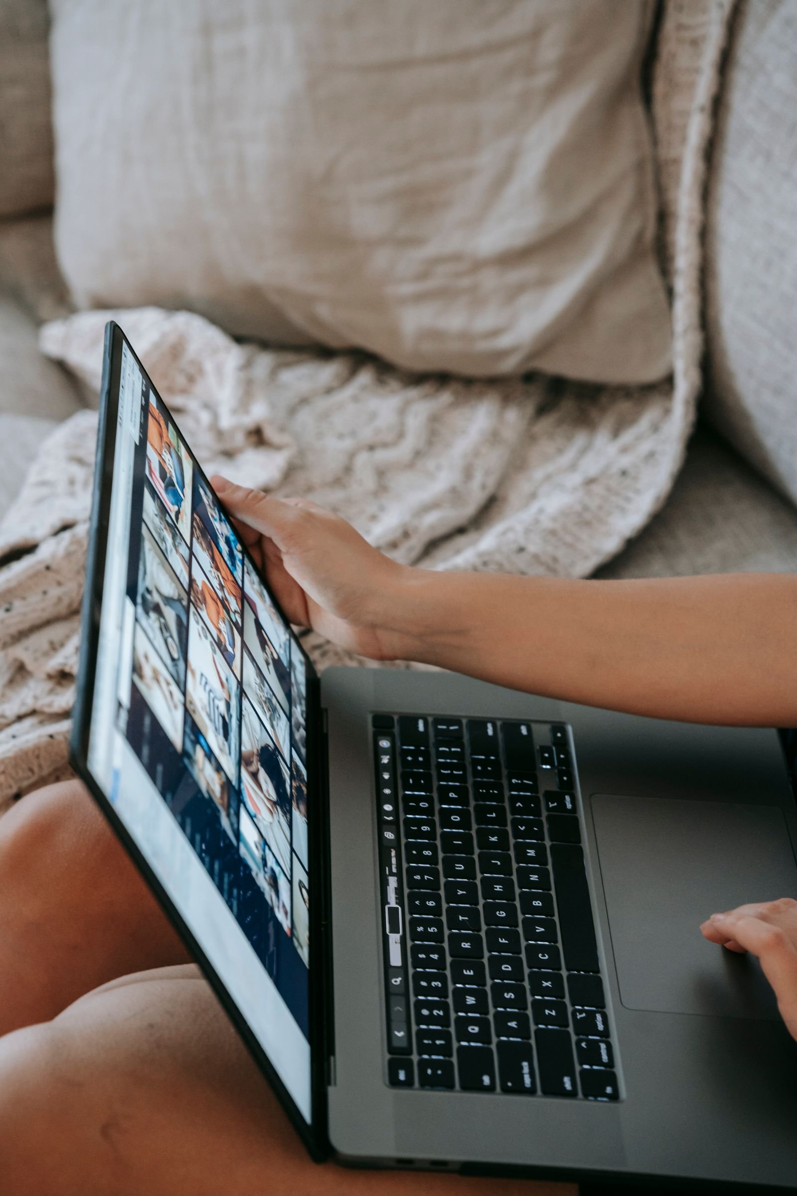 Person managing social media content on a laptop