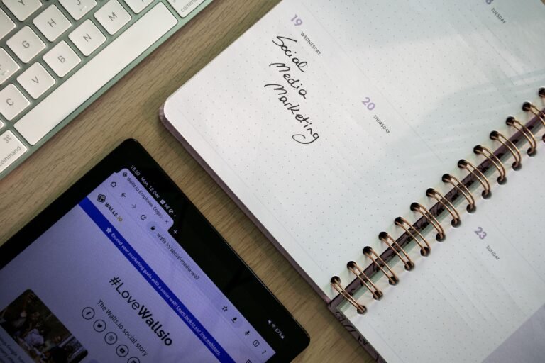 Notes and a tablet on a desk used for organizing social media posts