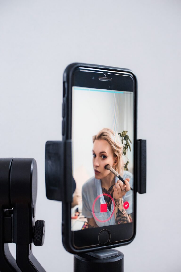 Content creator filming a video with a smartphone for a TikTok ad